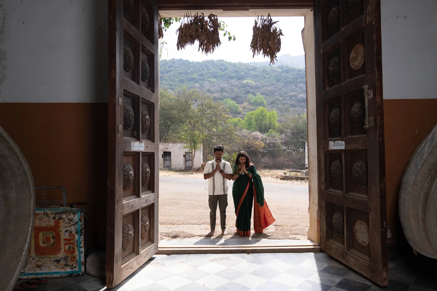 Couple framed in an old doorway with hills beyond